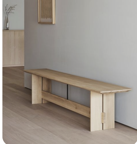 Long wooden bench with a low stretcher and exposed joinery