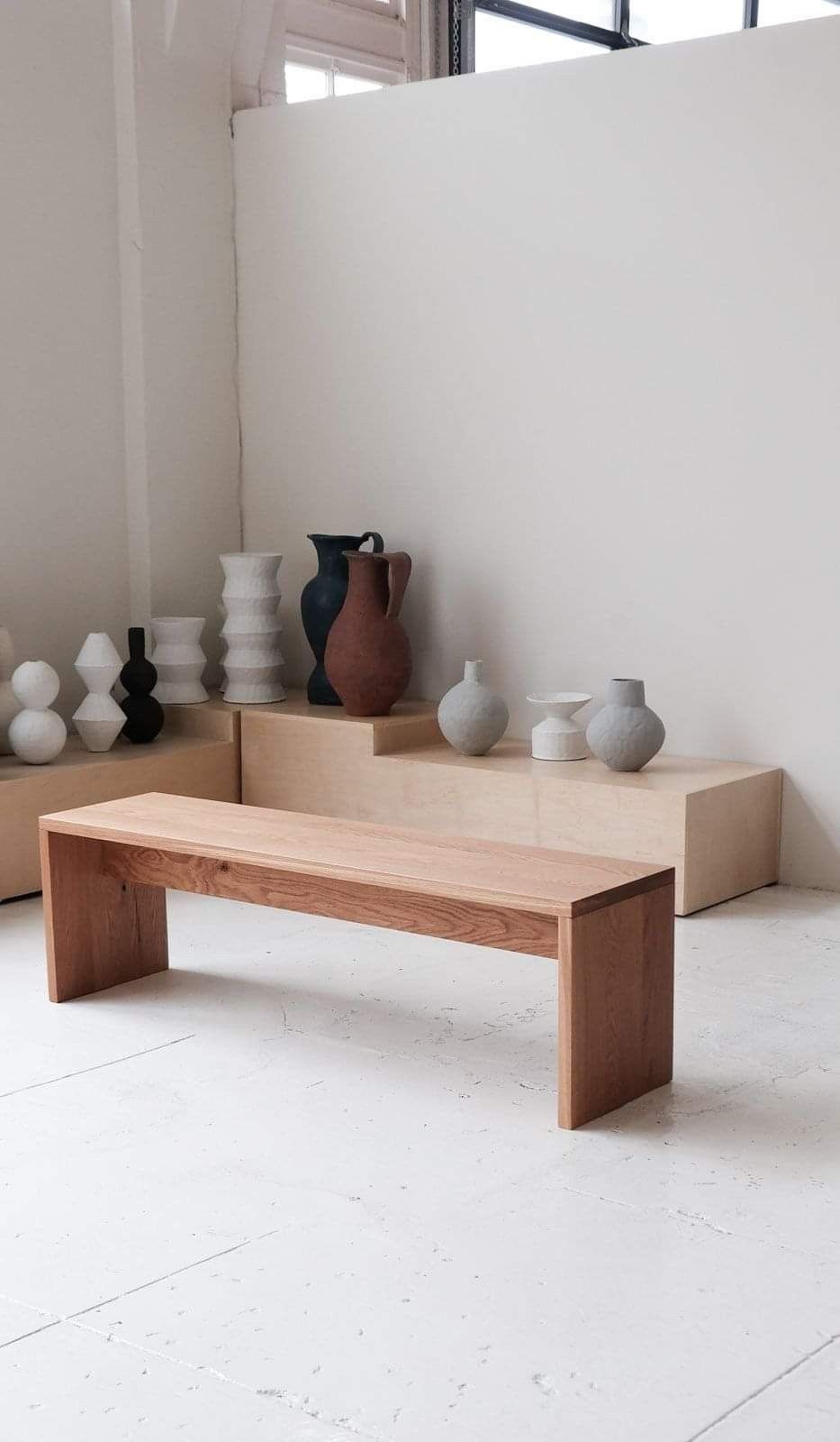 Warm-toned wooden bench in a pottery studio